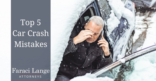 Man on phone getting out of snow-covered car